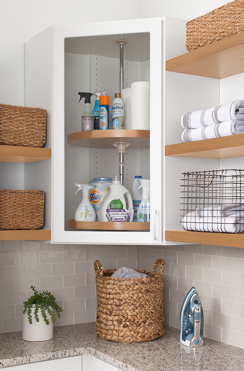 White lazy susan in a corner shelf for a custom laundry storage