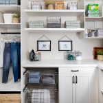 Custom floor mounted boutique laundry room storage with pull out hampers