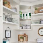 Custom floor mounted boutique laundry room storage with corner shelving