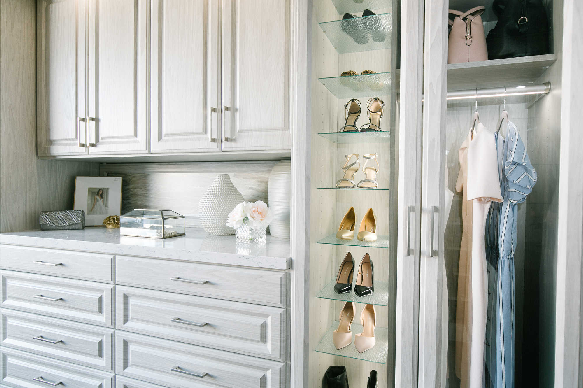 Beautiful floor mounted closet with glass door wardrobe and pull out drawers in Sacramento