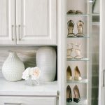 Beautiful floor mounted closet with glass door wardrobe to store shoes in Sacramento