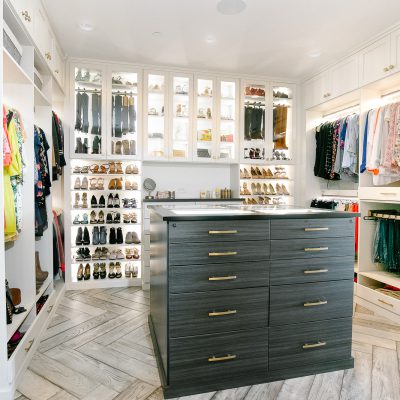 Custom floor mounted boutique closet with matte finishes and shoe storage in Sacramento