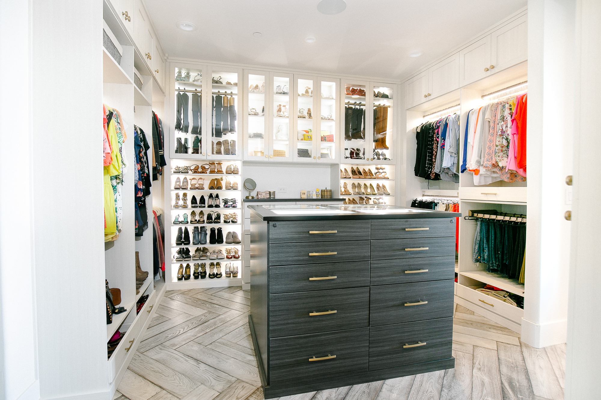 Custom floor mounted boutique closet with matte finishes and shoe storage in Sacramento