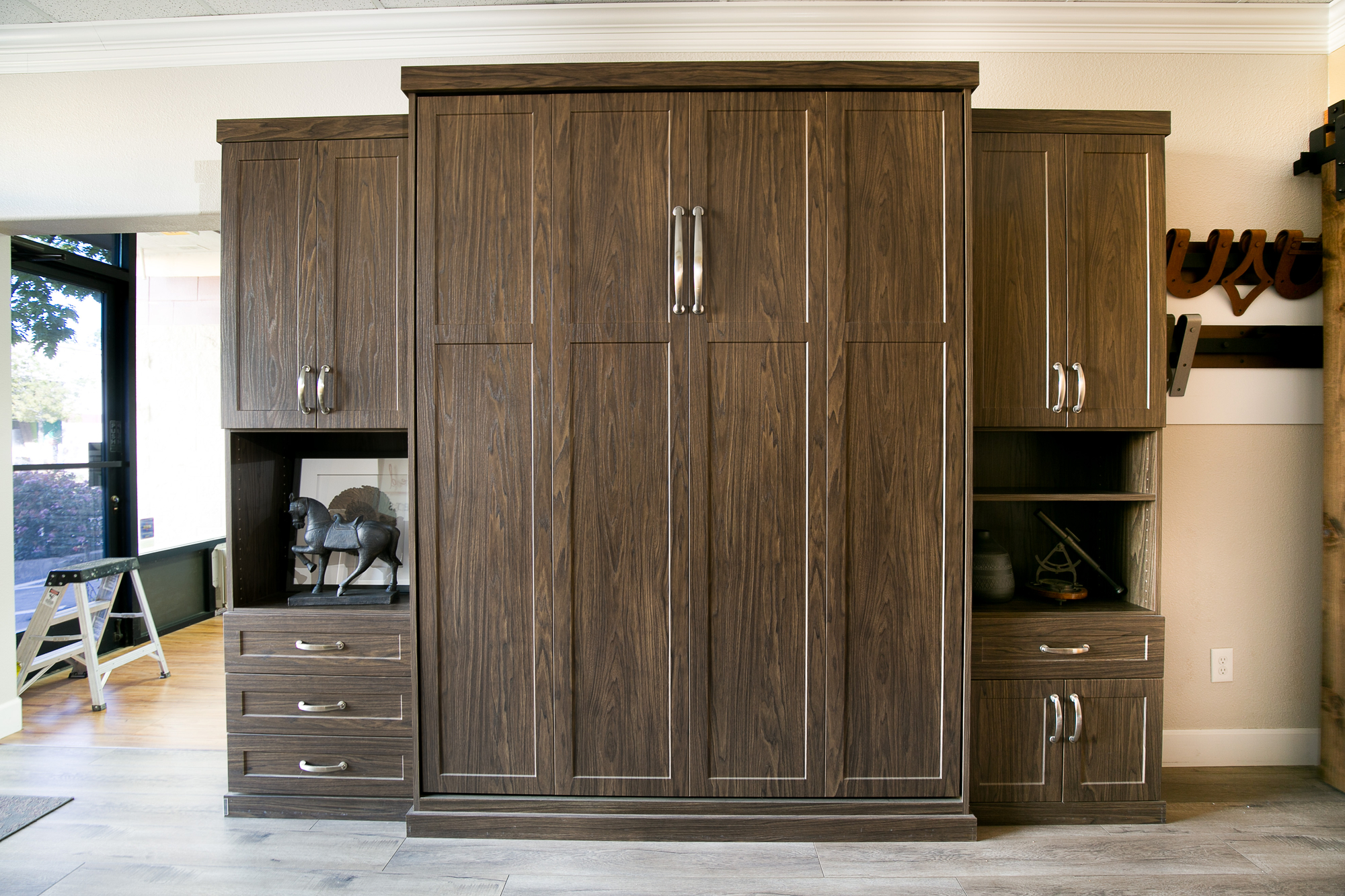 Folded up custom murphy bed with storage drawers and cabinets in Sacramento