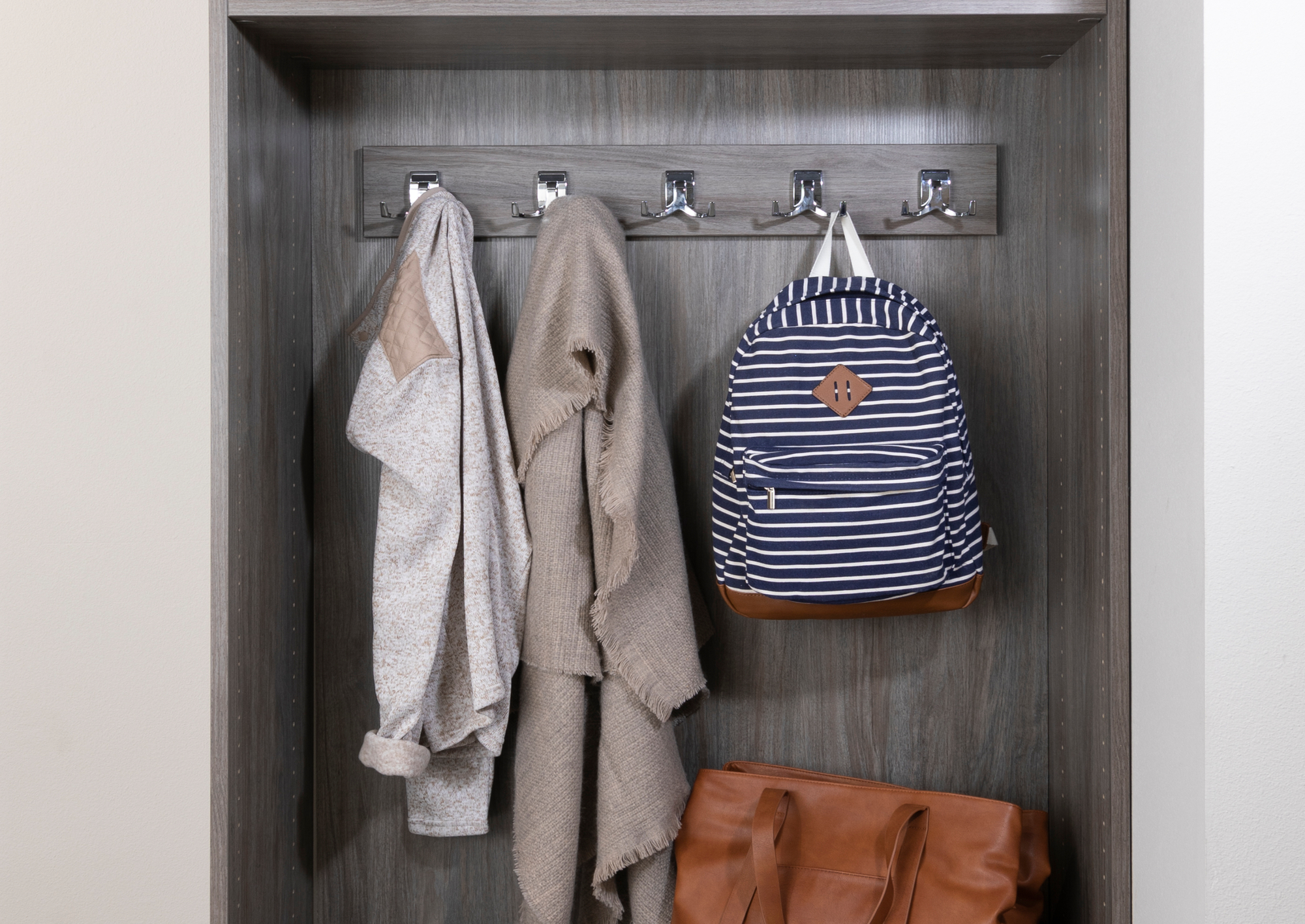 Custom driftwood entryway with hanging storage from Inspired Closets