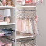 White little girls reach in closet with hanging rods for cloths in Las Vegas, NV