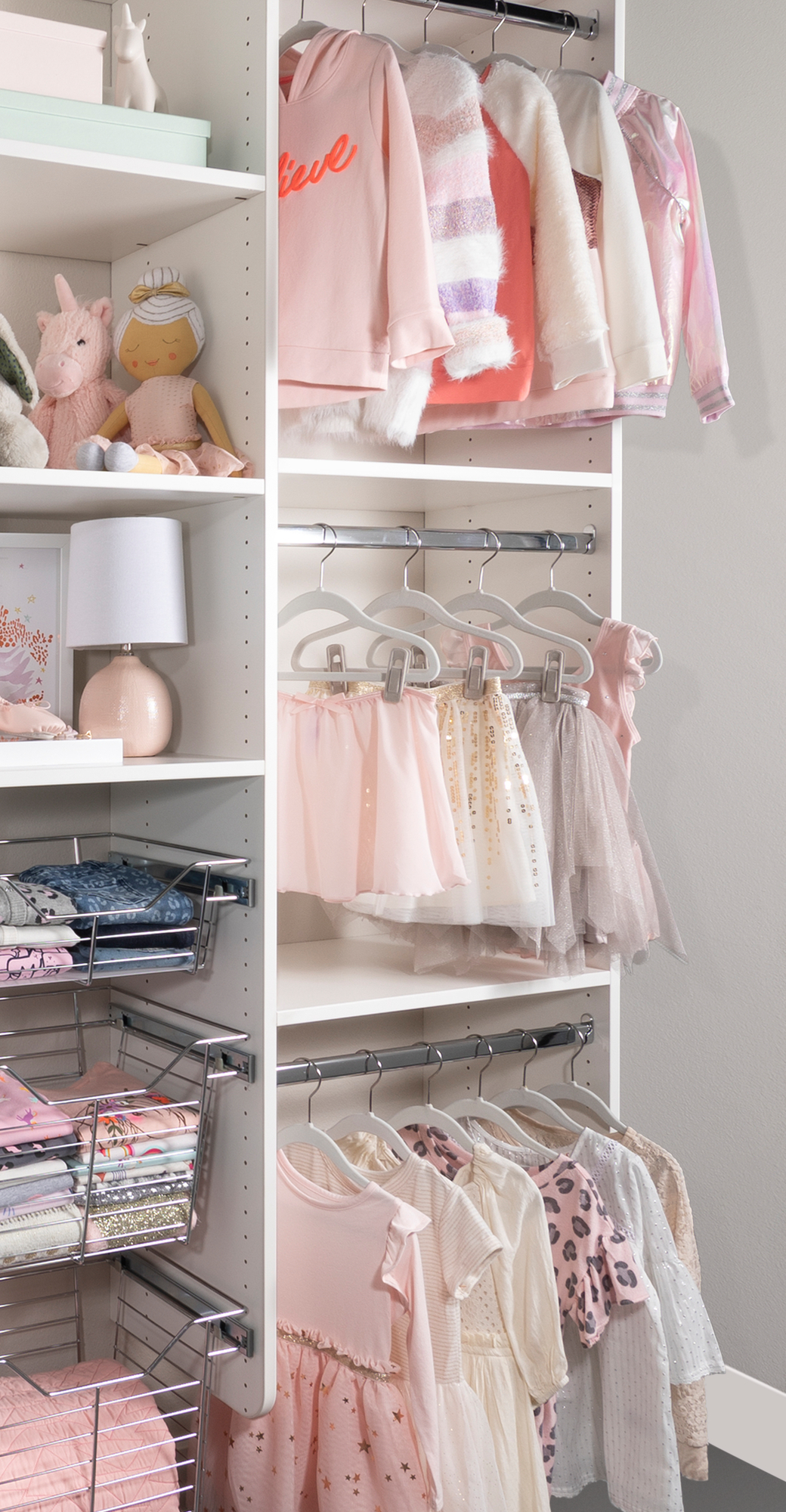 White little girls reach in closet with hanging rods for cloths in Las Vegas, NV