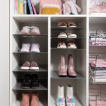 White little girls reach in closet with slanted shoe storage in Las Vegas, NV