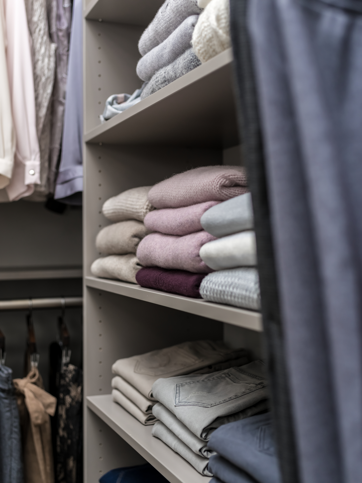 Custom storage shelving for a closet for all your sweaters and pants from Inspired Closets